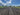 Plowed field under a blue sky with clouds